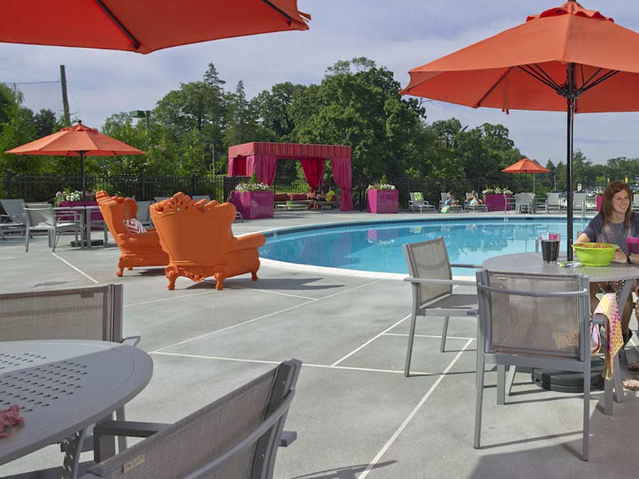 Jenkintown PA apartment swimming pool area with bright colored umbrellas and furniture