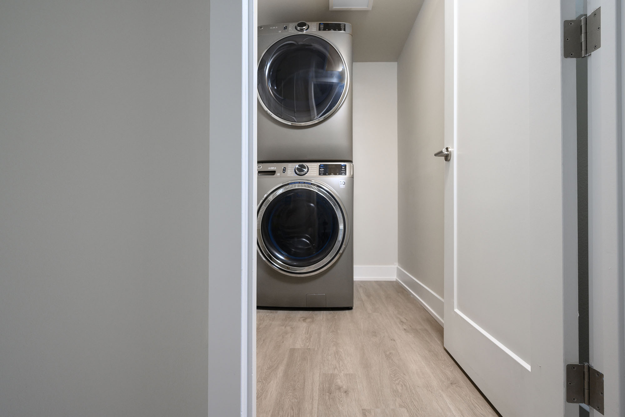 GE large capacity front-load washer and dryer in satin nickel in oversized laundry