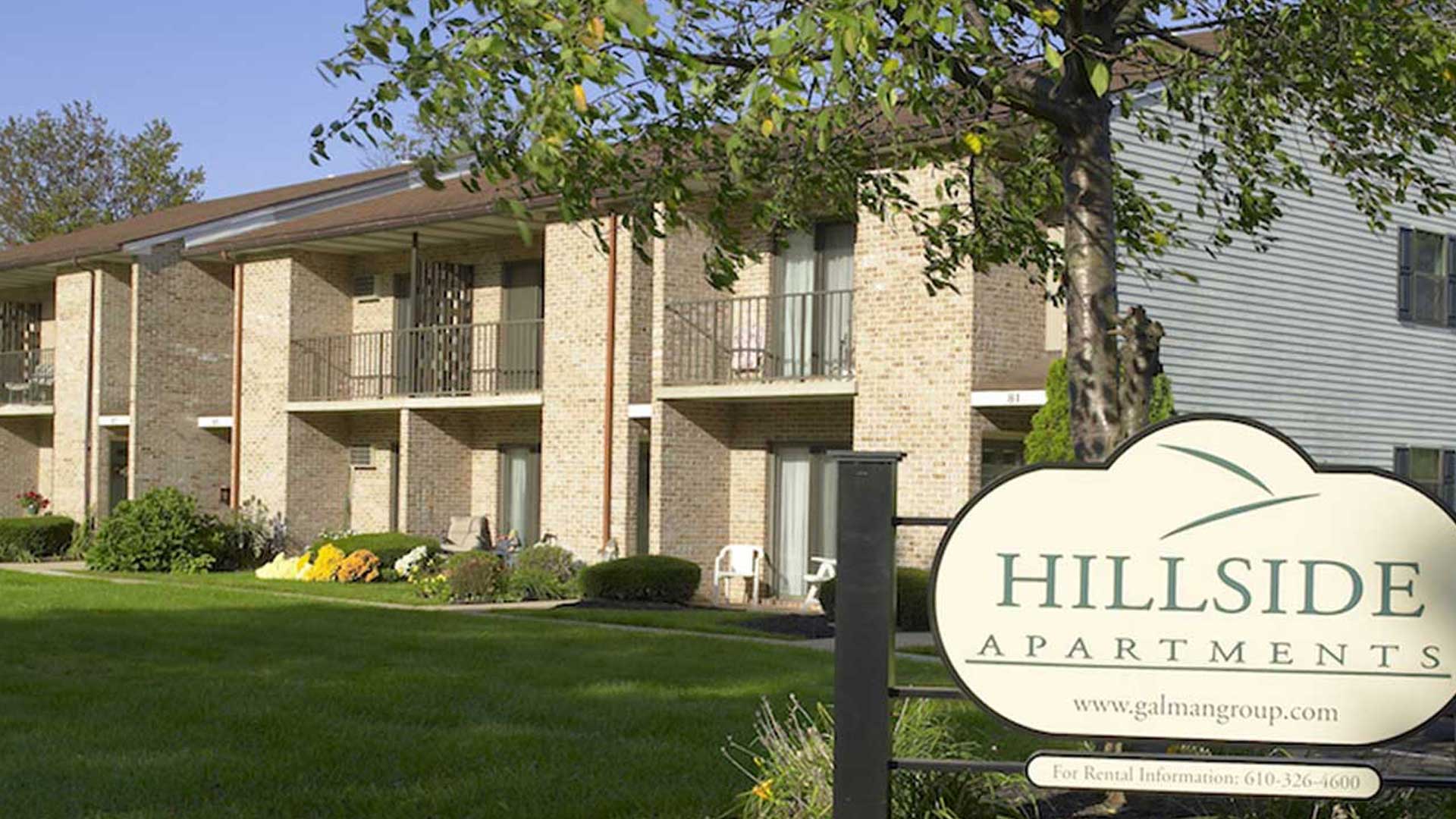 Hillside apartments building exterior with sign
